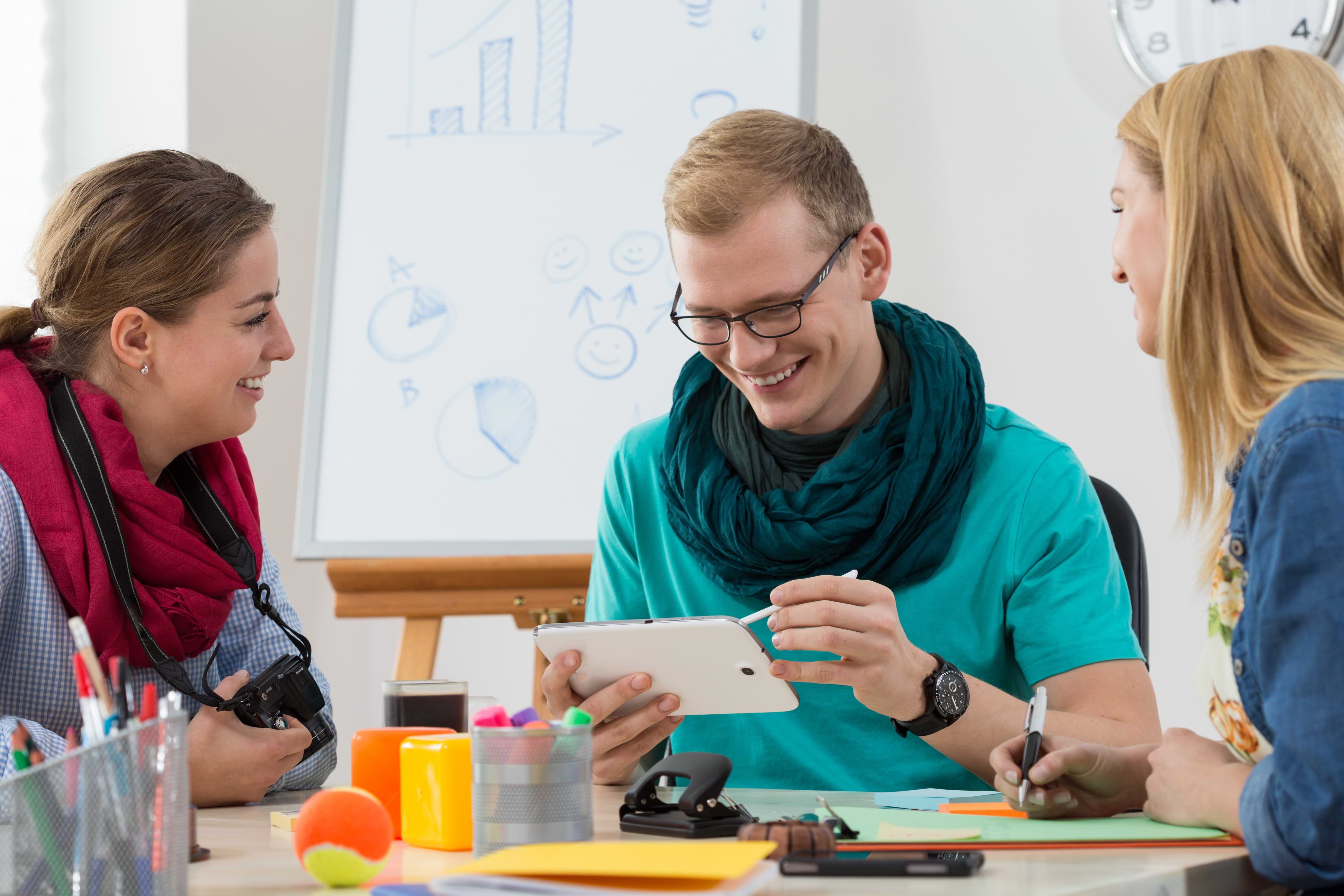 Group of young interns working at office